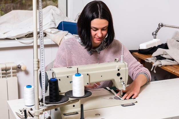 Seamstress works in the tailoring workshop