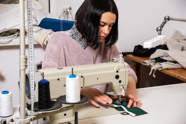 Seamstress works in the tailoring workshop