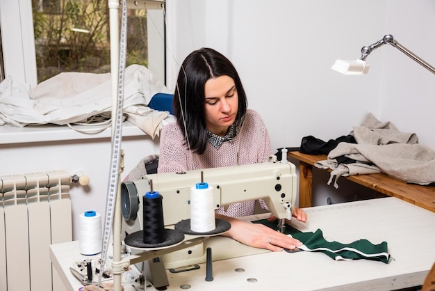 Seamstress works in the tailoring workshop