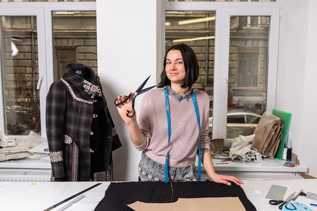 Seamstress works in the tailoring workshop