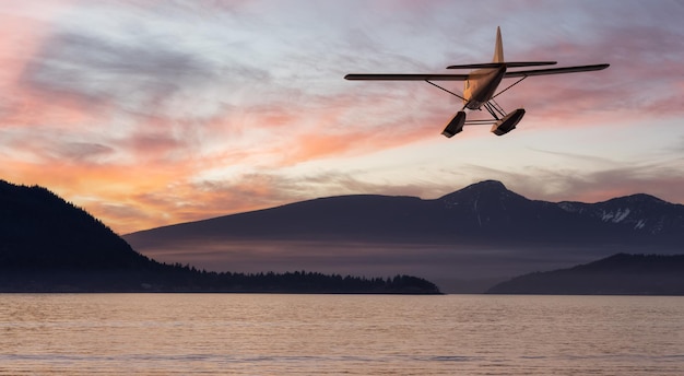 Seaplane flying over Canadian Mountain Nature Landscape on the Pacific West Coast