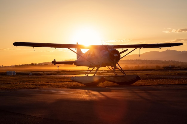 Seaplane parked at the airport during a vibrant summer sunset