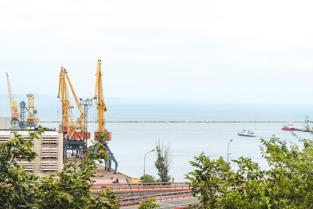 Seaport with tanks and cranes and other equipment.