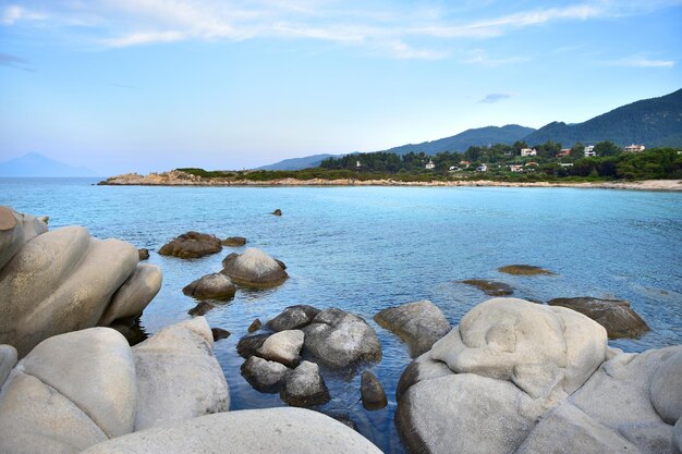 Seascape of a beautiful bay with stones and pines in Greece