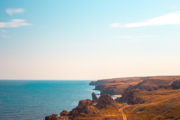 Seascape Blue sea and rocky mountains with blue skies on the horizon Travel and tourism