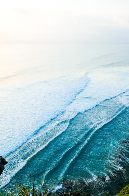 Seascape, ocean at sunset. Ocean coast with waves near Uluwatu temple at sunset, Bali, Indonesia.