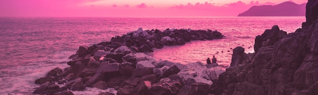 Seascape Rocky beach Sunset over rocky coast Cinque Terre Italy Horizontal banner