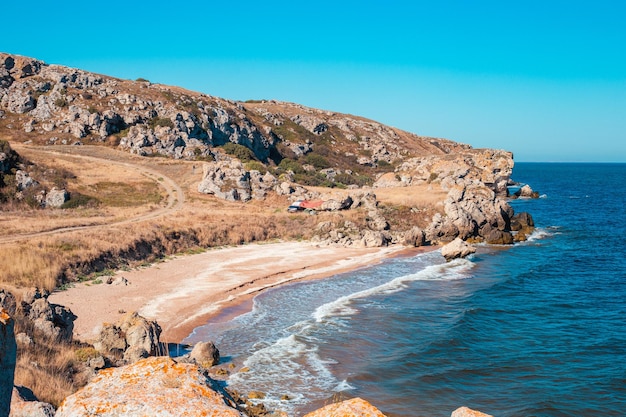 Seascape Rocky sea coast with a small wave on a sunny summer day General beaches of the Azov Sea