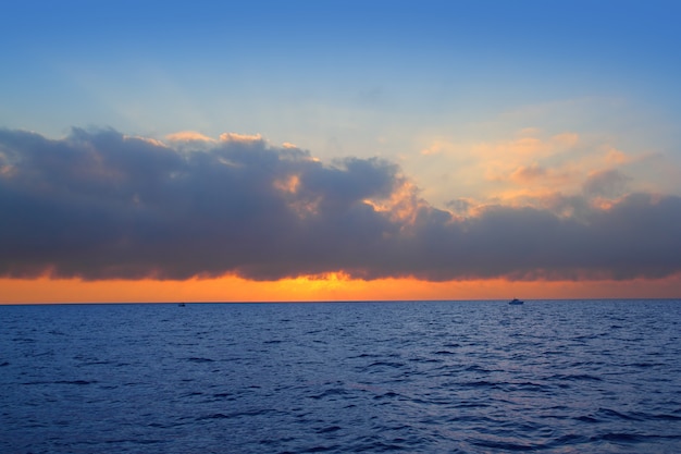 Seascape sunrise first sun orange in blue sea