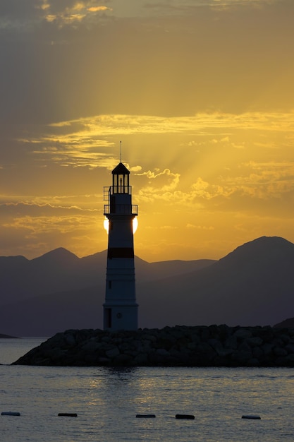 Seascape at sunshine Lighthouse and sailings on the coast Seaside town of Turgutreis and spectacular sunshine