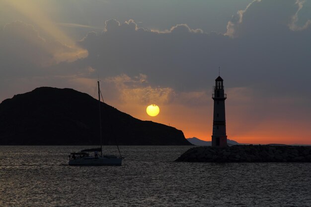 Seascape at sunshine Lighthouse and sailings on the coast Seaside town of Turgutreis and spectacular sunshine