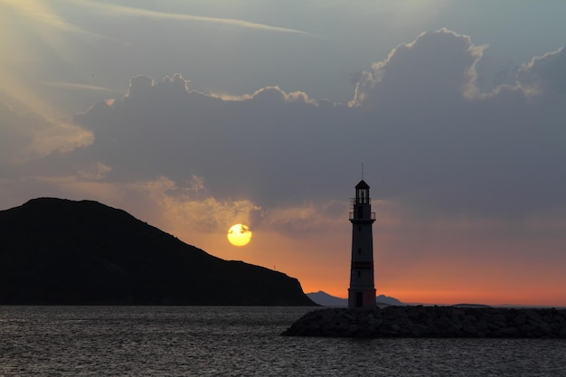 Seascape at sunshine Lighthouse and sailings on the coast Seaside town of Turgutreis and spectacular sunshine