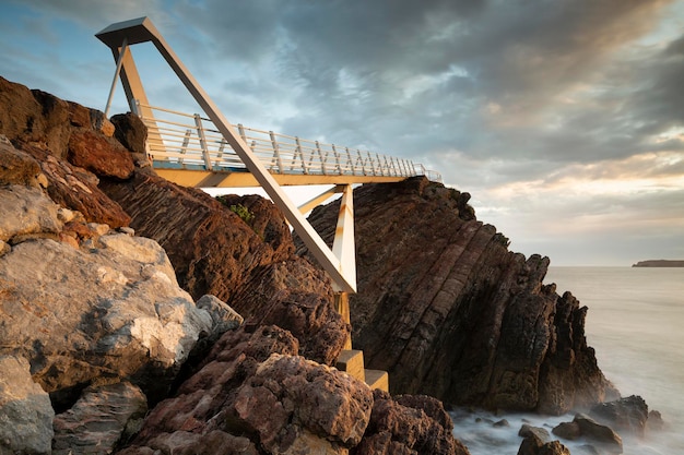 Seascape view of the long walkway of Las Gaviotas viewpoint located in Castrillon Asturias Spain