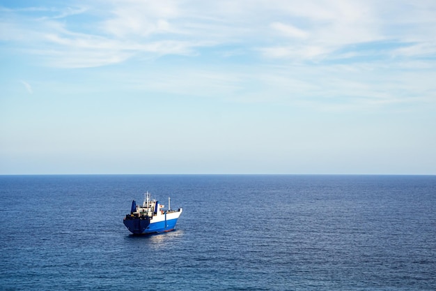 Seascape with calm sea clear sky and ship