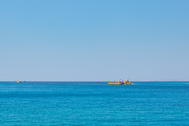 Seascape with ships against blue sky without clouds