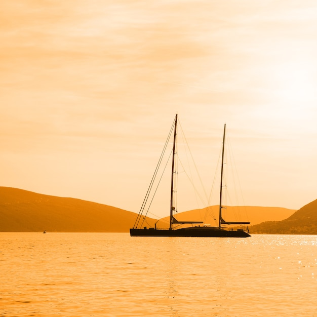 Seascape with silhouette of sail ship