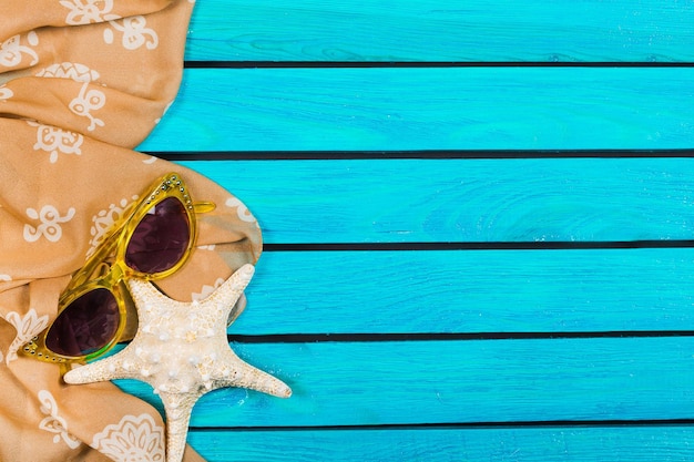 Seashell on blue wooden background. Travel concept