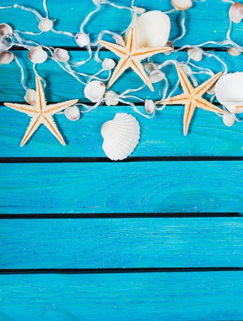 Seashells and sea stars On Blue Wooden Background with place for text