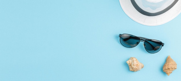 Seashells with beach hat and sunglasses