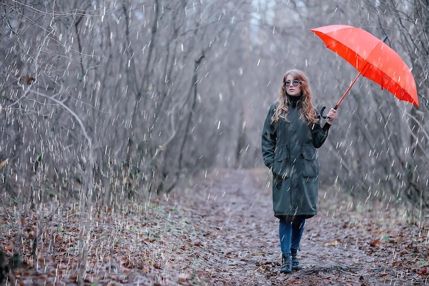 seasonal autumn portrait, sad girl with umbrella, november seasonal virus immunity on a walk