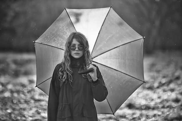 seasonal autumn portrait, sad girl with umbrella, november seasonal virus immunity on a walk