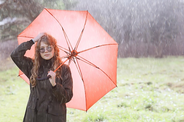 seasonal autumn portrait, sad girl with umbrella, november seasonal virus immunity on a walk