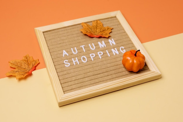 Seasonal Shopping Concept Letterboard with Message Fake Maple Leaves and Pumpkins Helloween