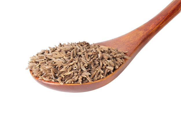 Seasoning cumin grain in wooden spoon isolated on white background