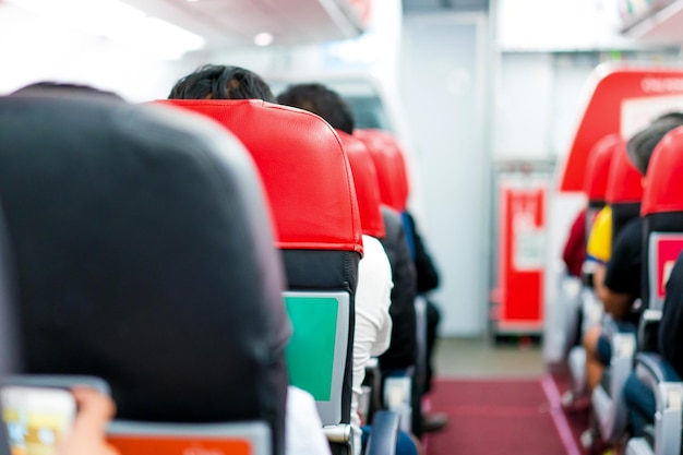 Seats in the airplane and passenger sitting all area waiting for the plane taking off from runway