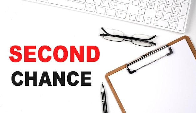 SECOND CHANCE text written on the white background with keyboard paper sheet and pen