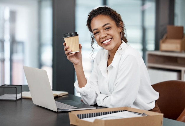 The secret behind my success Caffeine Cropped portrait of an attractive young businesswoman working at her desk in the office