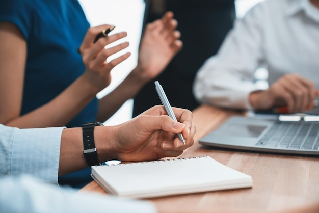 Secretary taking notes on notebook at corporate meeting with group of multiracial business people discussing together in meeting room Diversity in professional meeting at modern office Concord