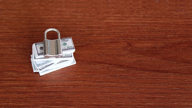 Security financial protection and saving money concept Stack of banknotes and padlock Copy space