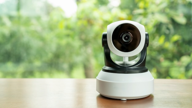 The security IP camera on a wooden table.