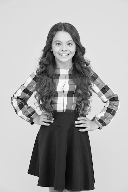 See her through school time in style Happy small girl in formal fashion style Little cute child smile with long curly hair style School uniform never goes out of style School dress code