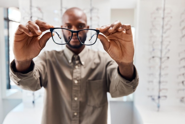 See us for an eye opening experience Shot of a young woman buying a new pair of glasses at an optometrist store