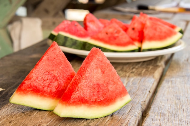 Seedless watermelon cut into wedges serving on dish