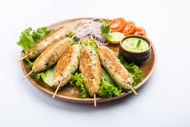 Seekh Kabab made with minced chicken or Mutton keema, served with green chutney and salad