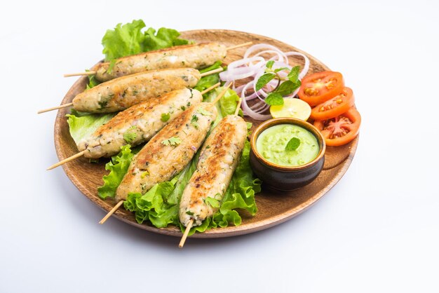 Seekh Kabab made with minced chicken or Mutton keema, served with green chutney and salad