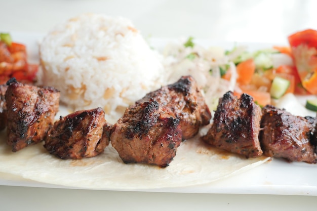 Seekh Kabab Naan bread and sauce on a plate