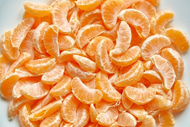 Segments of peeled tangerine Mandarin fruit background