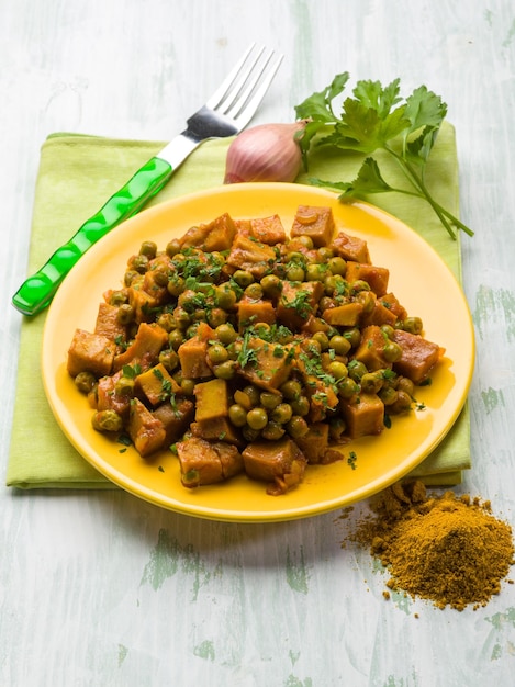 Seitan stew with peas and curry vegetarian food