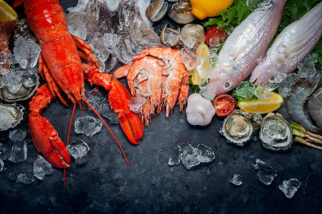 Selection of fresh lobster, shrimp, fish, oyster, squid and crab with lemon and ice cubes