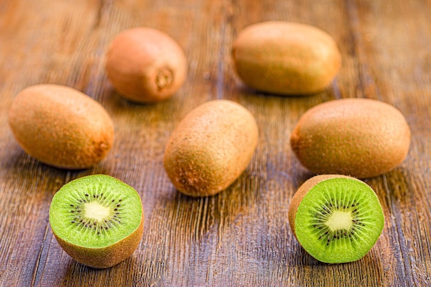 Selection of ripe green kiwi fruits on a wooden table