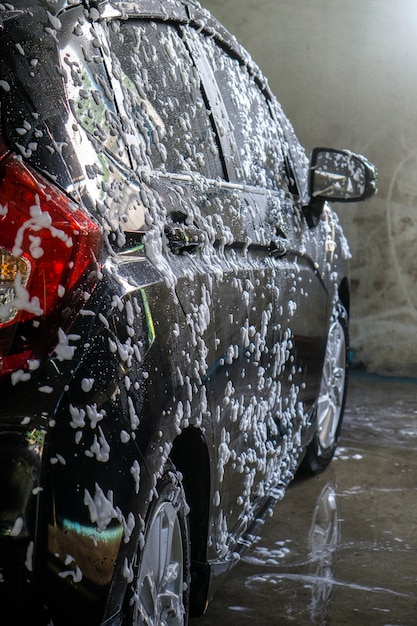 Selective focus of Black Car wash with soap