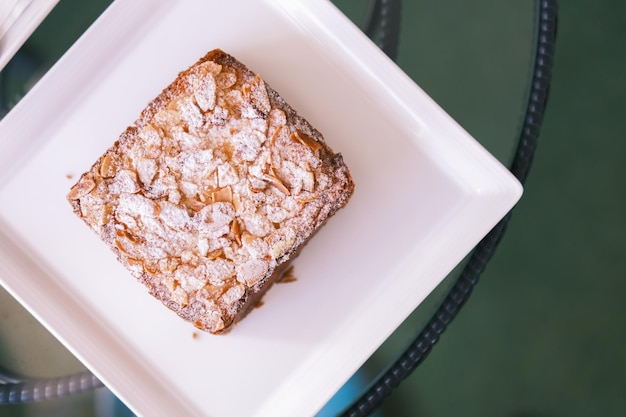 Selective focus Bostock with the addition of almond cream frangipane made of baked brioche slices close up view Traditional french sweet toast French patisserie almond toast