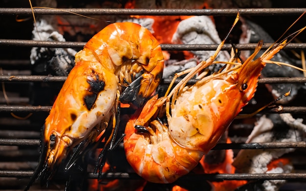 Selective Focus Delicious prawn spit on grill with flames.grilling shrimp on skewer 