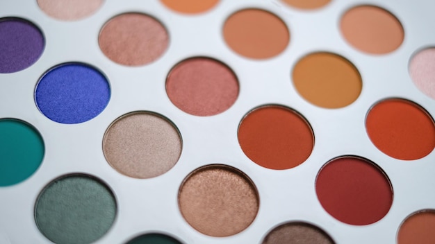 Selective focus of eyeshadow palette with various colors in pearly and matte closeup