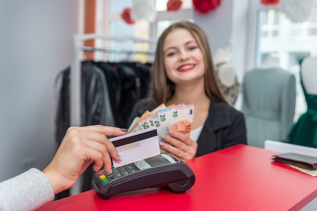 Selective focus on female hand with credit card