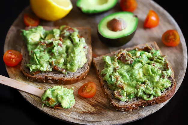 Selective focus Macro Guacamole toasts on a wooden board Healthly food Keto diet